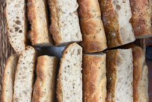 Load image into Gallery viewer, Several slices of focaccia bread with herbs, salt, and olive oil
